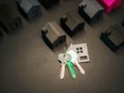 Close-up of a person's hand inserting a sleek, modern key into the lock of a front door, symbolizing unlocking a new busin...